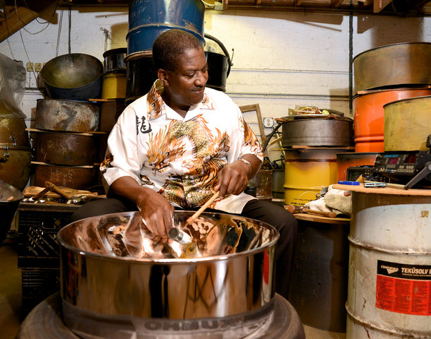 Michael tuning a steel pan (steel drum)