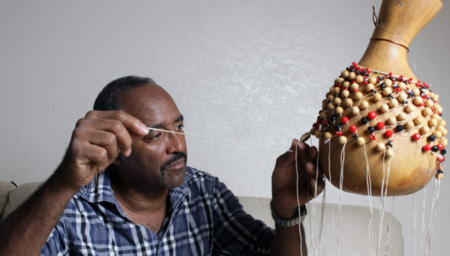 Crafting a shekeré (gourd rattle)