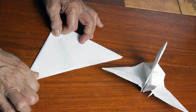 Mieko folding a pair of origami cranes