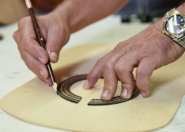 A rosette pattern is attached around the opening of the sound hole once the wood is cut