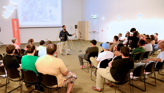 Crew member Rudi Goblen lectures on the history of hip hop