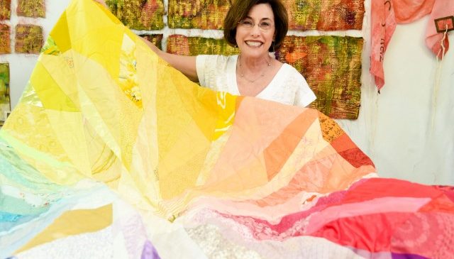 An art quilt piece titled Raggedy's Rainbow